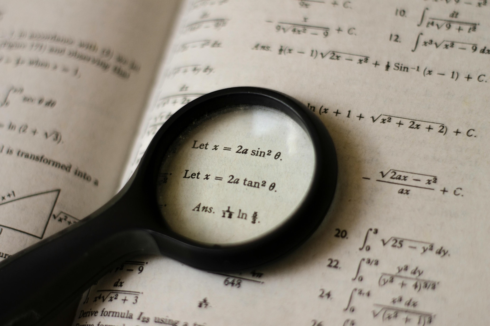 mathematics book with magnifier